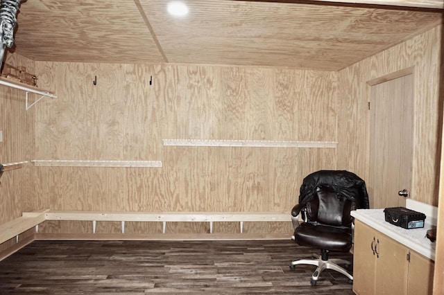 office area featuring dark hardwood / wood-style floors, wooden ceiling, and wood walls