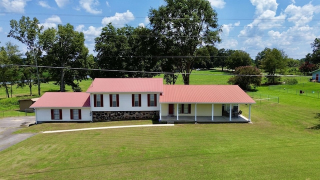 view of front facade with a front yard and a porch