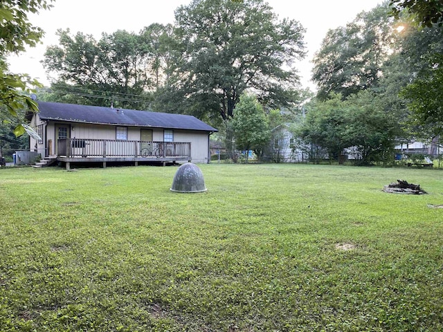  - view of green lawn with a wooden deck