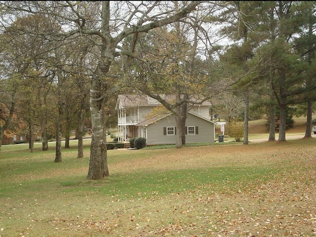  - view of property exterior featuring a yard