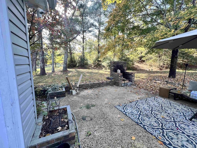  - view of patio / terrace with exterior fireplace