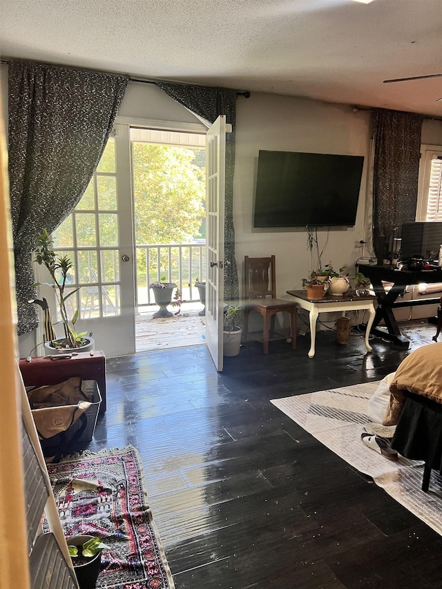 - living room with wood-type flooring and a textured ceiling