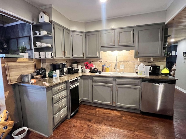  - kitchen with tasteful backsplash, stainless steel dishwasher, gray cabinetry, dark wood-type flooring, and dark stone countertops