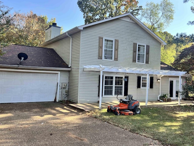  - view of front property with a garage and a pergola