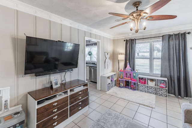 playroom featuring a sink, light tile patterned floors, a ceiling fan, and crown molding