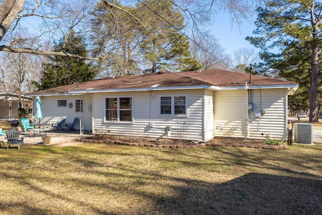 rear view of property featuring central air condition unit, a lawn, and a patio