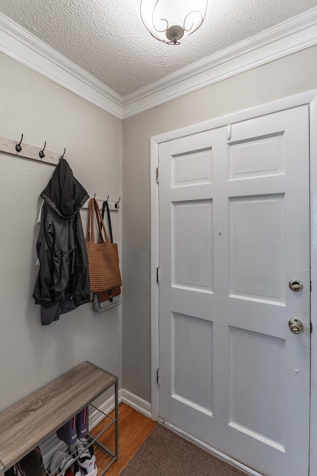 mudroom featuring a textured ceiling, baseboards, wood finished floors, and crown molding