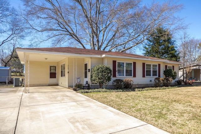 ranch-style home featuring central air condition unit, a carport, a front lawn, and concrete driveway