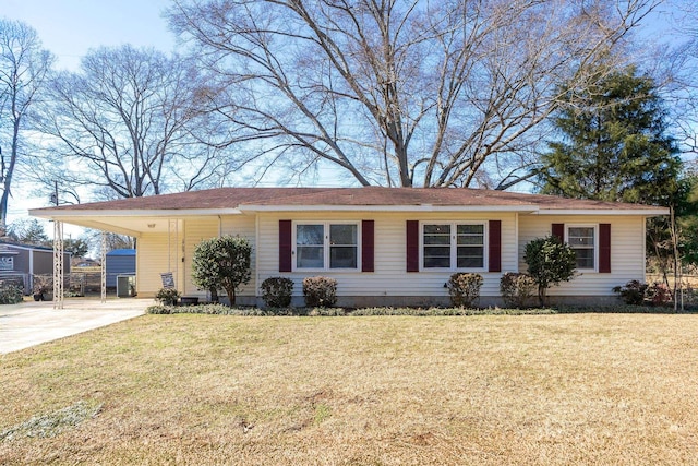 single story home featuring a front lawn, an attached carport, and concrete driveway