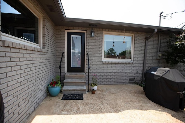  - property entrance with brick siding and crawl space