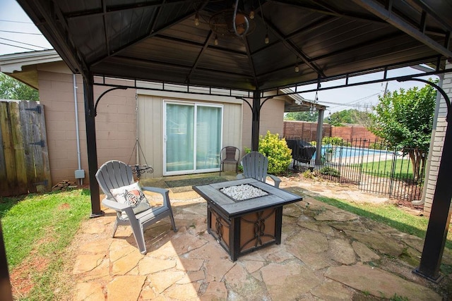  - fenced backyard featuring a fire pit, a gazebo, and a patio area