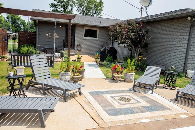  - view of patio with an outdoor fire pit and area for grilling
