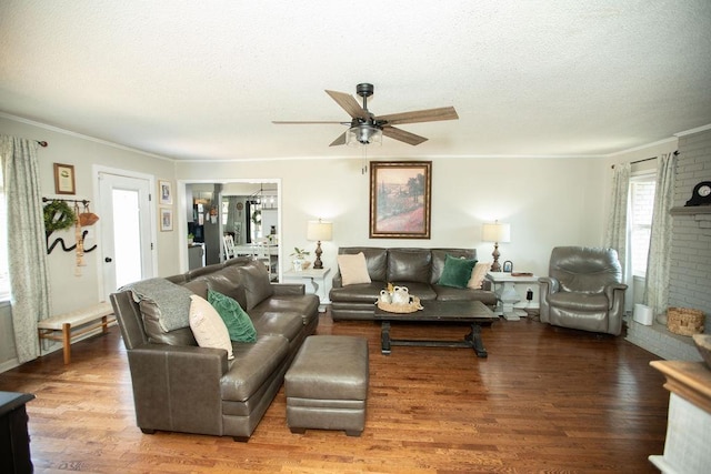  - living area featuring a textured ceiling, wood finished floors, a ceiling fan, and crown molding