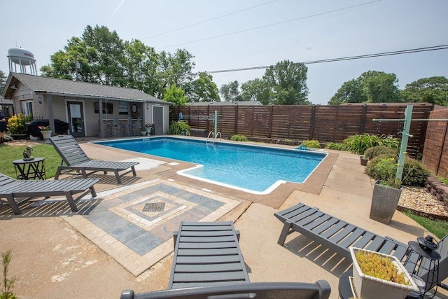  - view of pool with a fenced backyard and a patio