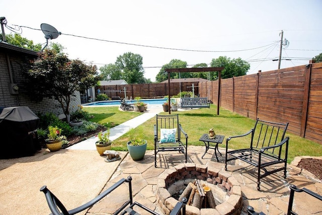  - fenced backyard with a grill, a patio, and a fire pit