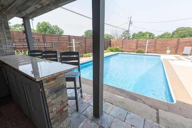  - view of swimming pool featuring a fenced backyard and a patio area