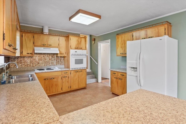 kitchen featuring white appliances, backsplash, ornamental molding, and sink