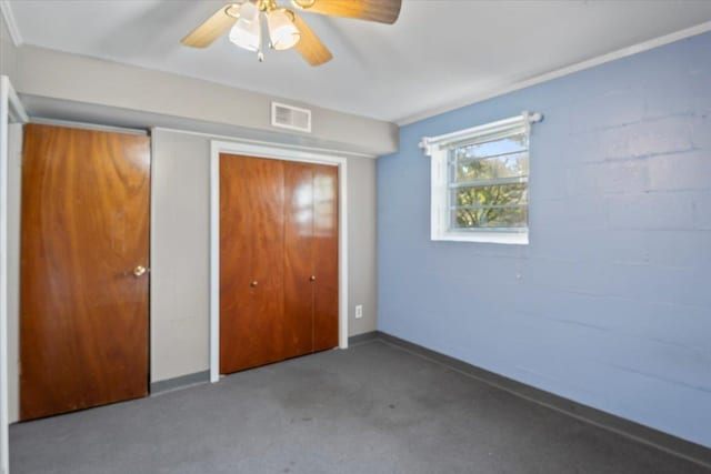 unfurnished bedroom featuring carpet flooring, ceiling fan, and a closet