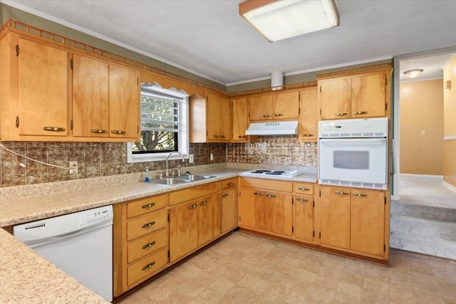 kitchen featuring backsplash, crown molding, sink, and white appliances