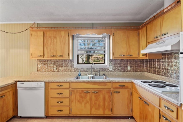 kitchen featuring white appliances, sink, and tasteful backsplash