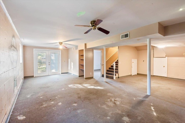 basement featuring ceiling fan, carpet floors, and french doors