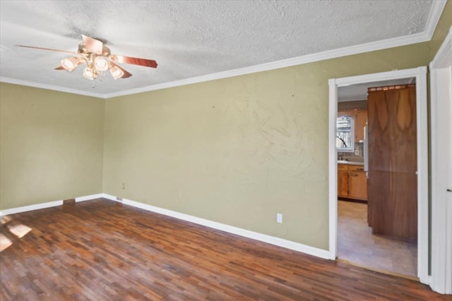 empty room featuring wood-type flooring, a textured ceiling, ceiling fan, and crown molding