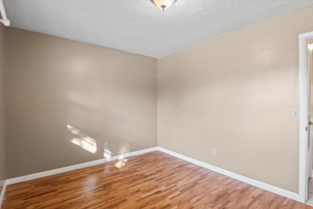 empty room featuring hardwood / wood-style flooring