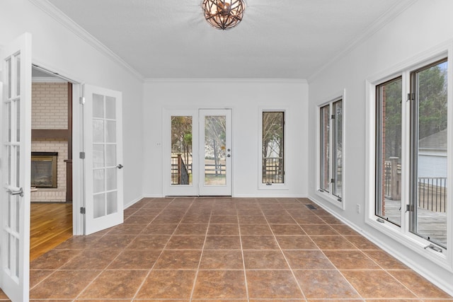 unfurnished sunroom with french doors and a brick fireplace