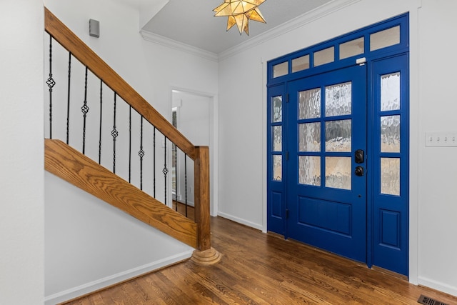 foyer featuring crown molding and dark hardwood / wood-style flooring