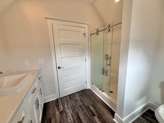  - full bath with a shower stall, wood finished floors, vanity, and baseboards