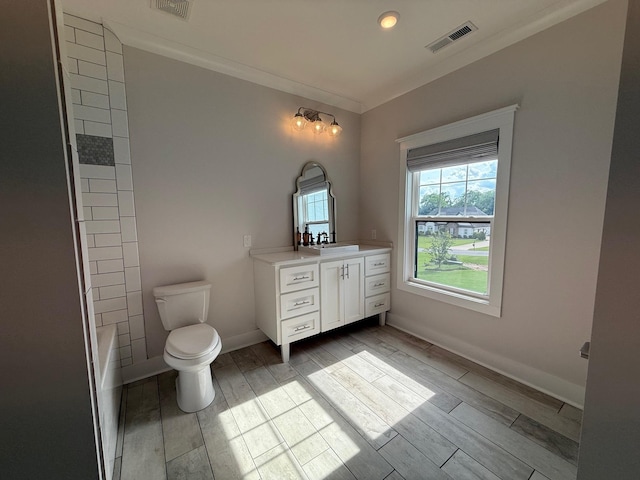  - full bath with vanity, crown molding, toilet, wood tiled floors, and baseboards