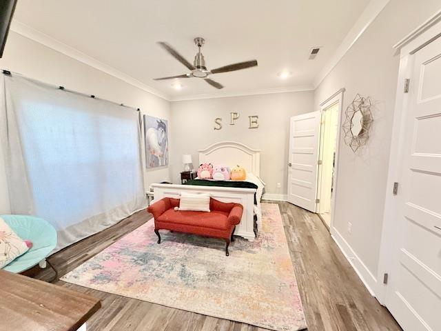  - bedroom featuring light wood-type flooring, crown molding, ceiling fan, baseboards, and recessed lighting