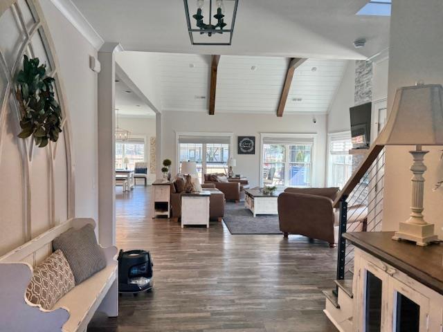  - living area featuring dark wood-style floors, a chandelier, and wooden ceiling
