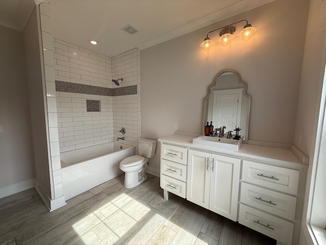  - full bathroom with vanity, wood finished floors, toilet, tub / shower combination, and recessed lighting