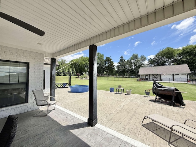  - view of patio featuring a hot tub and a deck