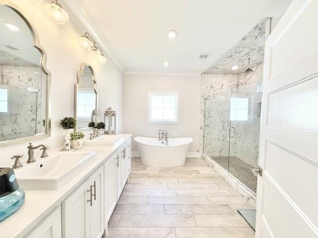  - full bathroom featuring a marble finish shower, ornamental molding, double vanity, and a freestanding tub