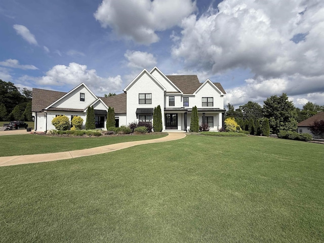 - view of front of house with a front yard, brick siding, and roof with shingles