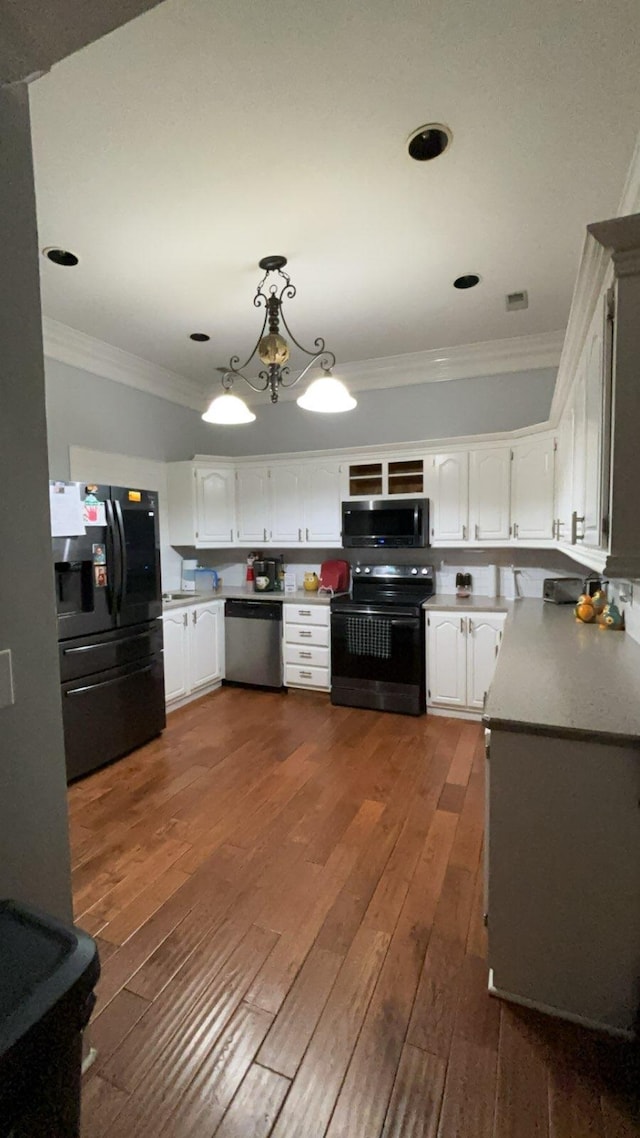 kitchen with white cabinetry, dark wood-type flooring, a chandelier, pendant lighting, and black appliances