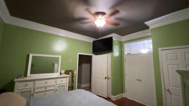 bedroom with ceiling fan, wood-type flooring, and ornamental molding