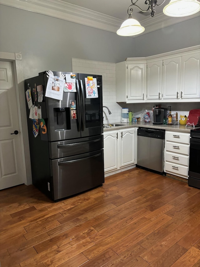 kitchen featuring decorative backsplash, white cabinetry, sink, and appliances with stainless steel finishes