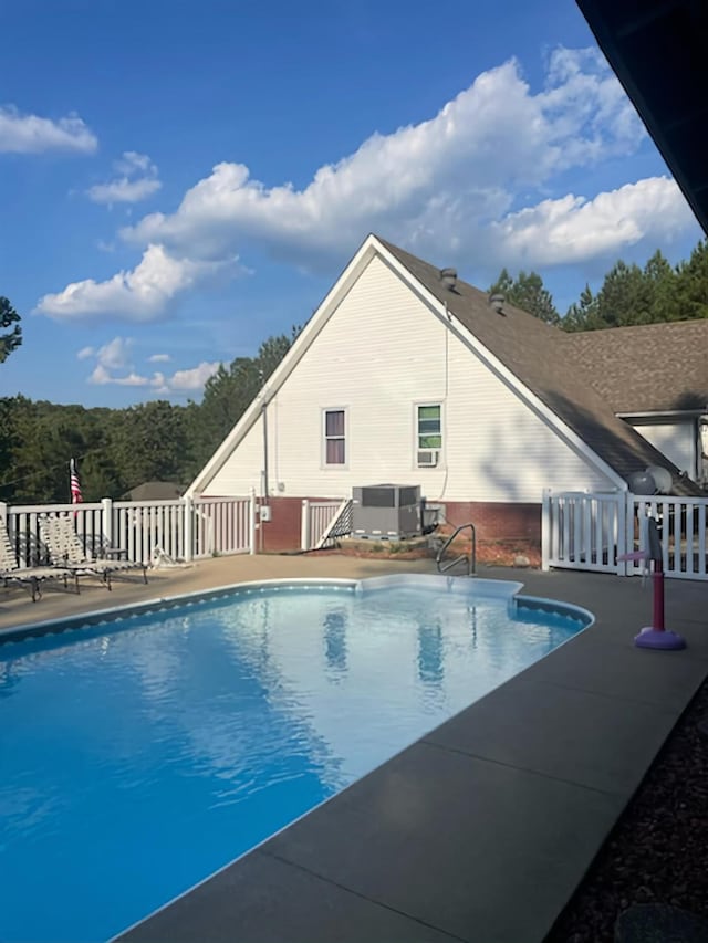 view of pool featuring a patio and central air condition unit