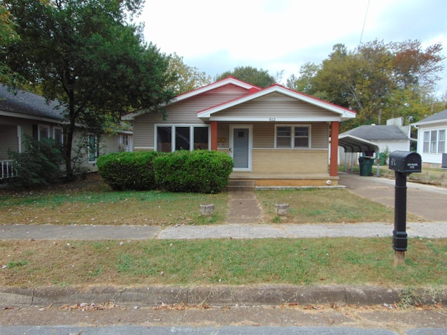 bungalow with covered porch and a carport