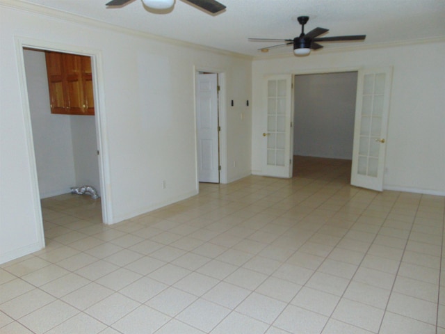 empty room featuring crown molding, french doors, and ceiling fan