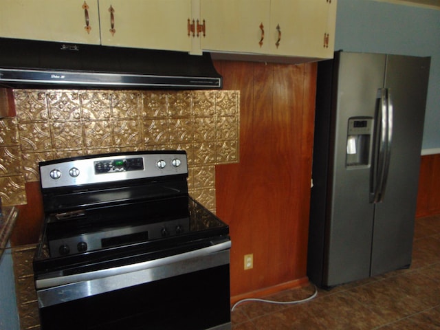 kitchen with stainless steel appliances, dark tile patterned flooring, and tasteful backsplash