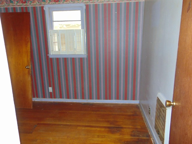 spare room featuring dark wood-type flooring