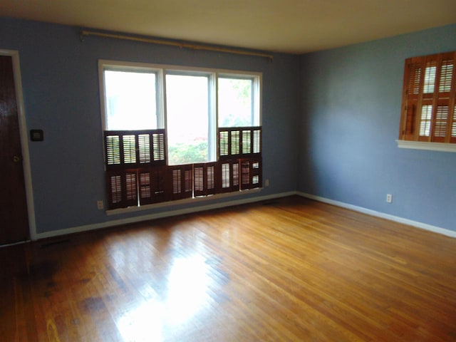 spare room with hardwood / wood-style flooring