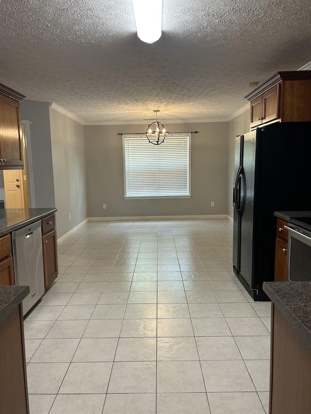 kitchen featuring baseboards, crown molding, appliances with stainless steel finishes, and dark countertops