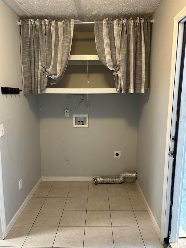 laundry area featuring hookup for an electric dryer, laundry area, a textured ceiling, tile patterned floors, and hookup for a washing machine