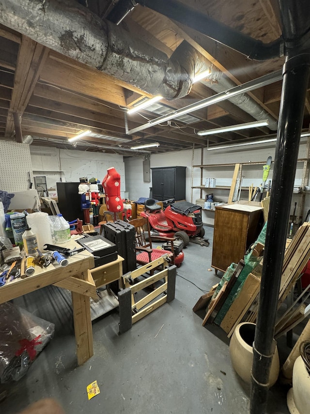 garage featuring electric panel and a workshop area