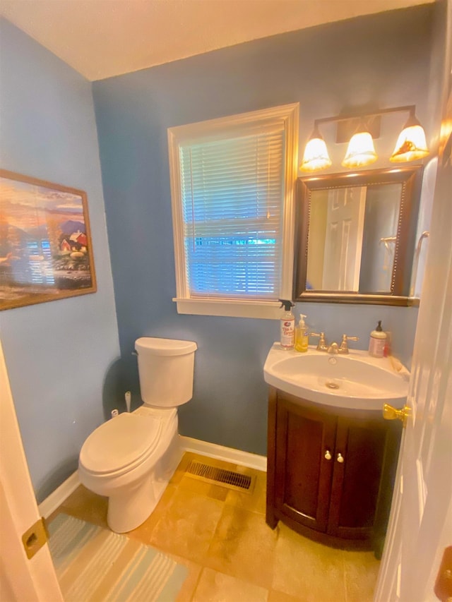 bathroom with tile patterned floors, vanity, and toilet